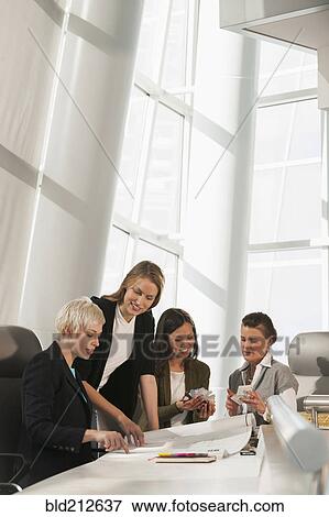 Stock Photo - Businesswomen talking in meeting. Fotosearch