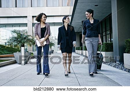 Businesswomen walking together outdoors View Large Photo Image Stock Image - Businesswomen walking together outdoors. Fotosearch