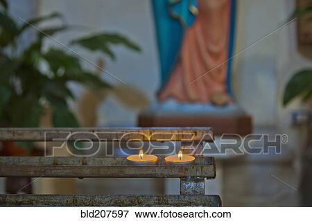 Stock Photo - Candles in a church in Rome. Fotosearch