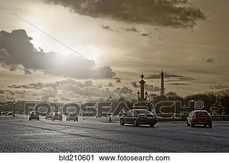 Stock Image - Cars driving on city street, Paris, France. Fotosearch