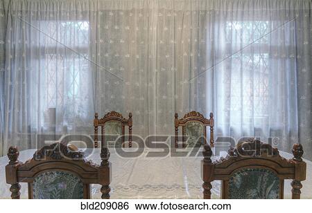 Carved wooden chairs at table in dining room View Large Photo Image Stock Photograph - Carved wooden chairs at table in dining room. Fotosearch