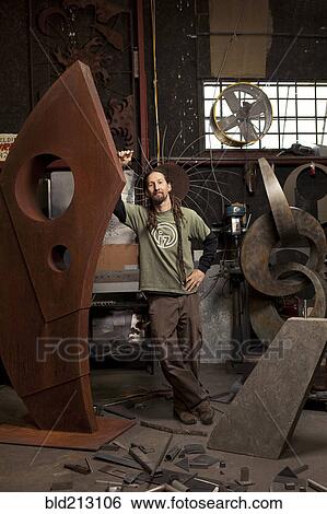 Stock Photograph - Caucasian artist standing in studio. Fotosearch