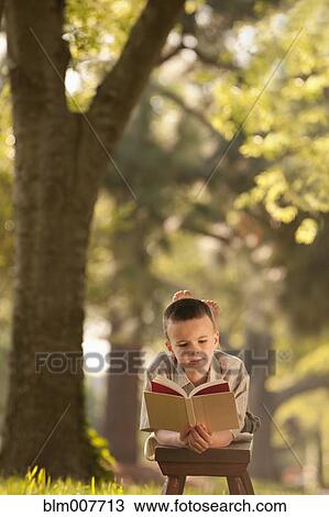 Caucasian boy reading book in yard View Large Photo Image Stock Image - Caucasian boy reading book in yard. Fotosearch