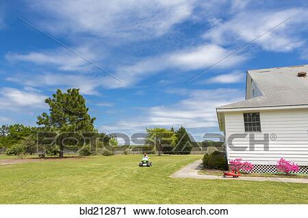 Caucasian boy riding four wheeler in backyard View Large Photo Image Stock Image - Caucasian boy riding four wheeler in backyard. Fotosearch