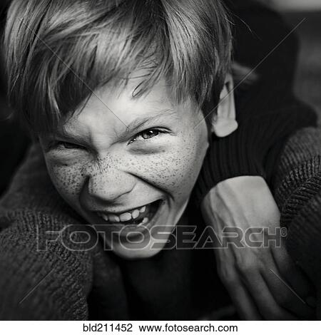 Stock Image - Caucasian boy with freckles laughing. Fotosearch