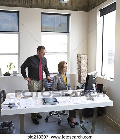 Caucasian business people talking in office View Large Photo Image Stock Photo - Caucasian business people talking in office. Fotosearch