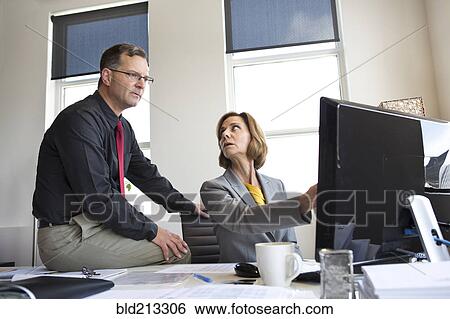 Caucasian business people talking in office View Large Photo Image Stock Photograph - Caucasian business people talking in office. Fotosearch