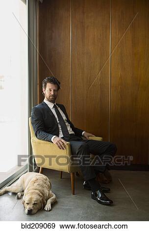 Stock Photo - Caucasian businessman sitting in armchair. Fotosearch