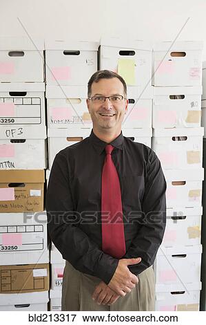 Stock Photo - Caucasian businessman smiling in office. Fotosearch
