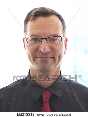 Stock Photo - Caucasian businessman smiling in office. Fotosearch