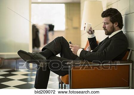 Stock Image - Caucasian businessman using cell phone. Fotosearch