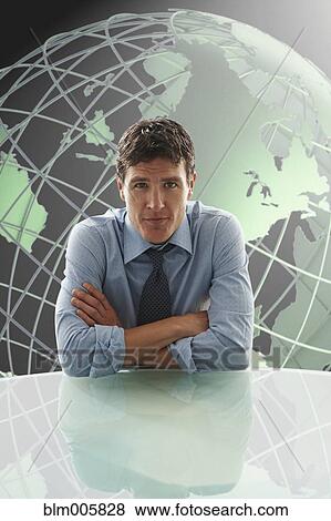 Caucasian businessman with globe in background View Large Photo Image Stock Photo - Caucasian businessman with globe in background. Fotosearch