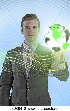 Stock Photo - Caucasian businessman with glowing globe. Fotosearch