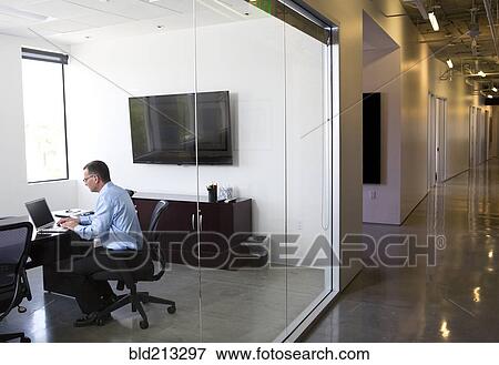 Stock Photo - Caucasian businessman working in office. Fotosearch