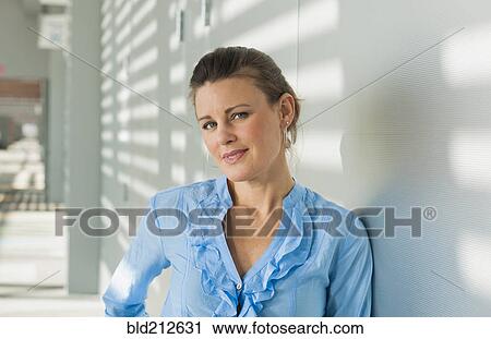 Stock Image - Caucasian businesswoman smiling in office. Fotosearch