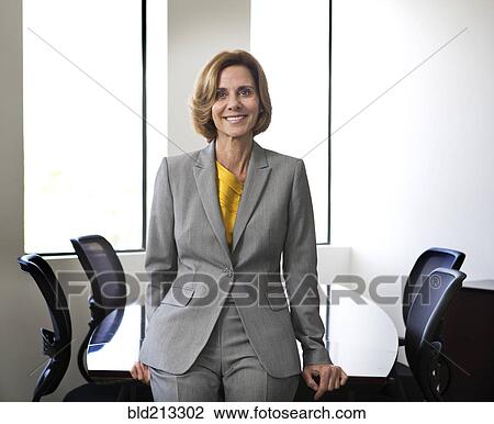 Stock Image - Caucasian businesswoman smiling in office. Fotosearch