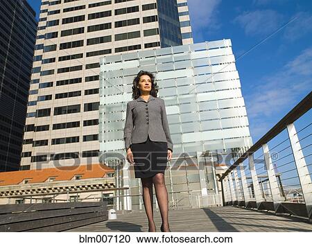 Caucasian Businesswoman standing in city View Large Photo Image Stock Image - Caucasian Businesswoman standing in city. Fotosearch