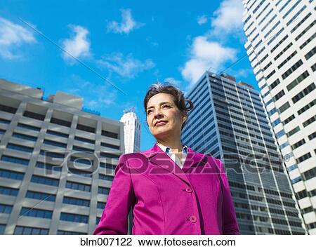 Caucasian Businesswoman standing in city View Large Photo Image Stock Image - Caucasian Businesswoman standing in city. Fotosearch