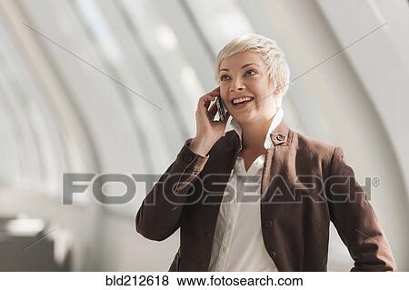 Stock Photo - Caucasian businesswoman talking on cell phone. Fotosearch