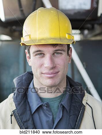 Stock Image - Caucasian construction worker smiling outdoors. Fotosearch