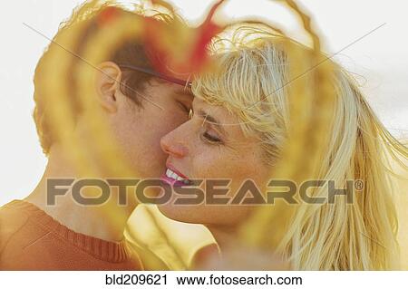 Stock Image - Caucasian couple holding woven heart. Fotosearch
