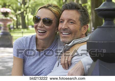 Caucasian couple hugging in park View Large Photo Image Stock Image - Caucasian couple hugging in park. Fotosearch