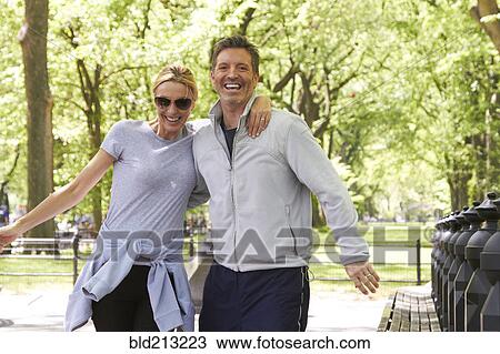 Caucasian couple hugging in park View Large Photo Image Stock Image - Caucasian couple hugging in park. Fotosearch