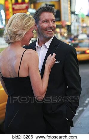 Stock Photograph - Caucasian couple hugging in Times Square, New York City, New York, United States. Fotosearch