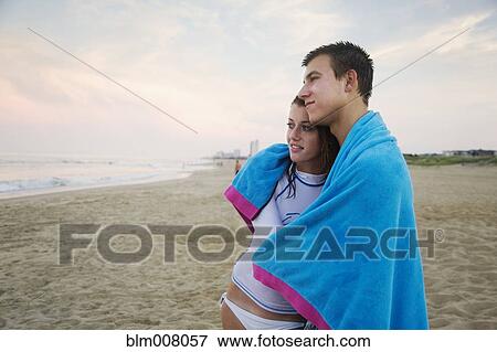 Caucasian couple hugging on beach View Large Photo Image Stock Photo - Caucasian couple hugging on beach. Fotosearch