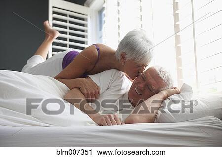 Caucasian couple kissing in bed View Large Photo Image Stock Image - Caucasian couple kissing in bed. Fotosearch