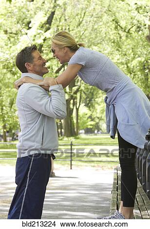 Picture - Caucasian couple playing in park. Fotosearch