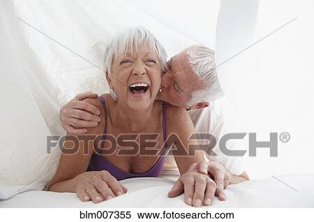 Caucasian couple playing under sheet in bed View Large Photo Image Stock Photography - Caucasian couple playing under sheet in bed. Fotosearch