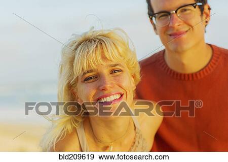 Caucasian couple smiling outdoors View Large Photo Image Stock Photo - Caucasian couple smiling outdoors. Fotosearch