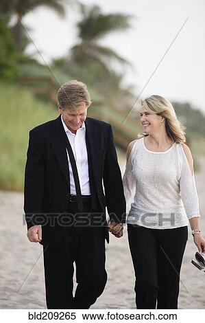 Caucasian couple walking on beach View Large Photo Image Stock Photography - Caucasian couple walking on beach. Fotosearch