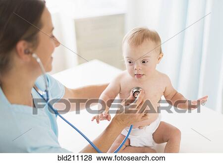 Stock Photo - Caucasian doctor tending to baby girl with Down Syndrome. Fotosearch