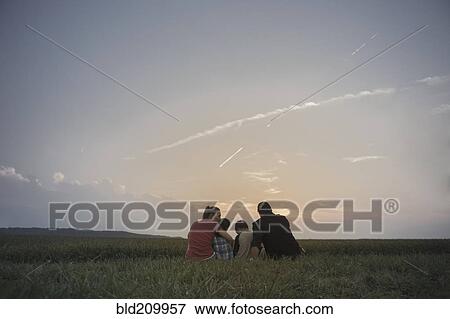 Stock Photo - Caucasian family overlooking crop fields. Fotosearch