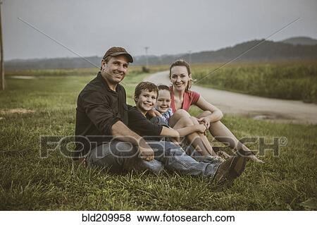 Stock Photo - Caucasian family overlooking crop fields. Fotosearch