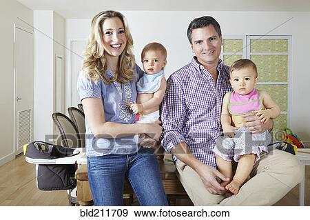 Caucasian family smiling in dining room View Large Photo Image Stock Photo - Caucasian family smiling in dining room. Fotosearch
