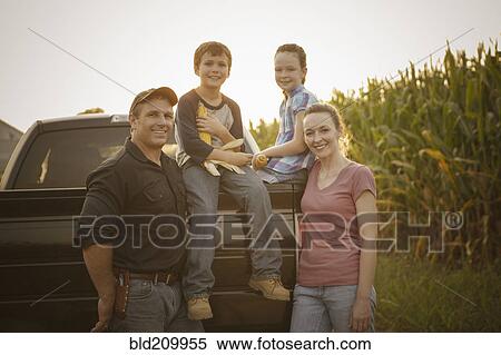 Stock Photography - Caucasian family smiling on truck. Fotosearch