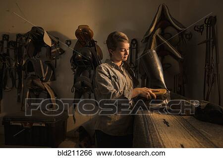 Caucasian girl caring for boots in horse stable View Large Photo Image Stock Photograph - Caucasian girl caring for boots in horse stable. Fotosearch
