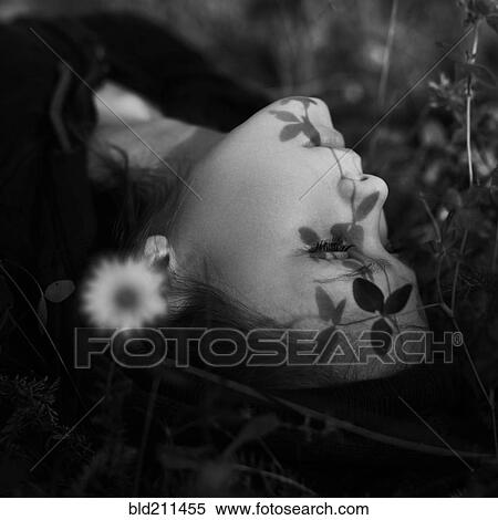 Caucasian girl laying in grass View Large Photo Image Stock Photography - Caucasian girl laying in grass. Fotosearch