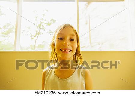 Stock Photograph - Caucasian girl showing gaps in teeth. Fotosearch
