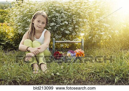 Caucasian girl sitting with basket of flowers View Large Photo Image Stock Photo - Caucasian girl sitting with basket of flowers. Fotosearch