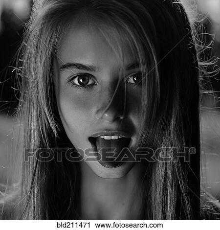 Stock Image - Caucasian girl sticking out her tongue. Fotosearch