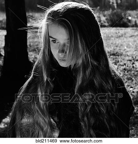 Stock Photo - Caucasian girl walking in forest. Fotosearch