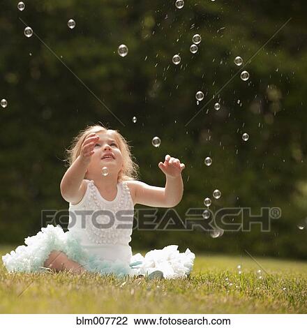 Caucasian girl watching floating bubbles View Large Photo Image Stock Image - Caucasian girl watching floating bubbles. Fotosearch