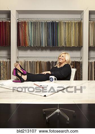 Caucasian interior designer sitting in studio View Large Photo Image Stock Photo - Caucasian interior designer sitting in studio. Fotosearch
