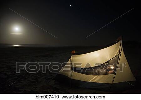 Caucasian man camping on beach View Large Photo Image Stock Image - Caucasian man camping on beach. Fotosearch