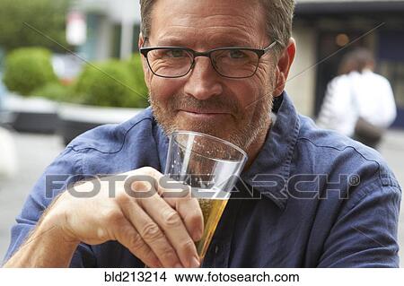 Caucasian man drinking beer outdoors View Large Photo Image Picture - Caucasian man drinking beer outdoors. Fotosearch