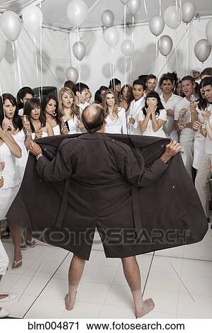 Stock Image - Caucasian man flashing party-goers. Fotosearch